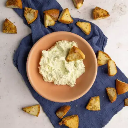 A bowl of creamy dip with pita chips&mdash;one of our favorite easy summer dips.