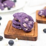 Blueberry Cookies stacked on a small wooden board.