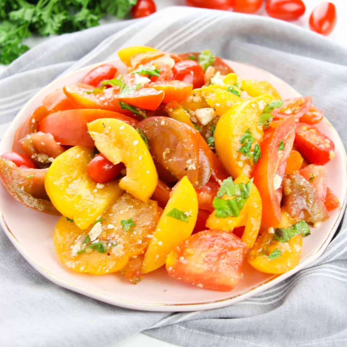 Close up of Heirloom Tomato Salad with crumbled Feta and drizzled Balsamic dressing.