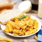 Sausage Rigatoni and bread on a white plate.