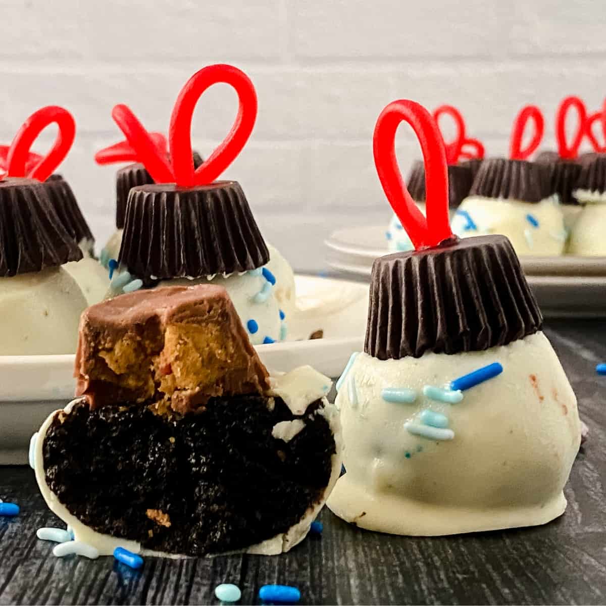 Christmas themed oreo truffles with one cut in half.