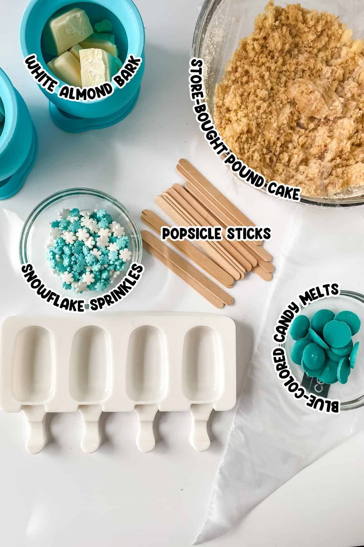 White almond bark, pound cake, snowflake sprinkles, popsicle sticks, and blue colored candy melts.