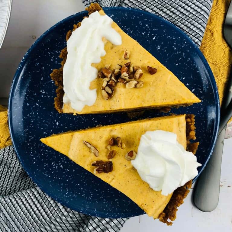 Slices of Pumpkin Chiffon Pie topped with whipped cream and toasted pecans.