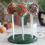 Colorful donut cake pops coated with assorted Christmas sprinkles.