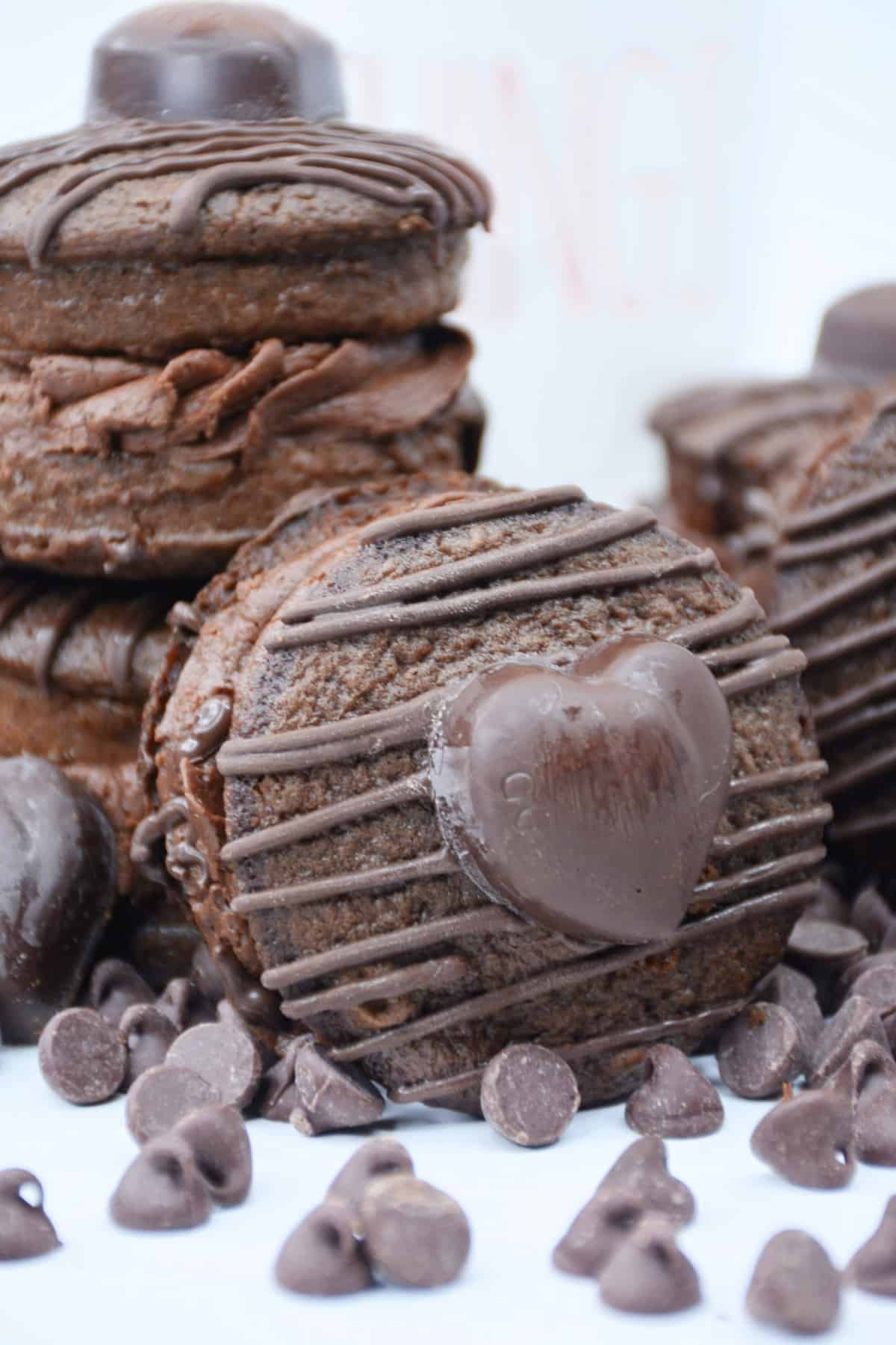 Chocolate whoopie pie leaning on two stacks of chocolate whoopie pies.