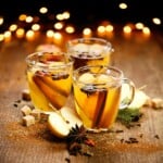 Three glass mugs of Mulled Apple Cider.