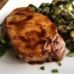 Balsamic pork chops with Brussels sprouts on a plate.