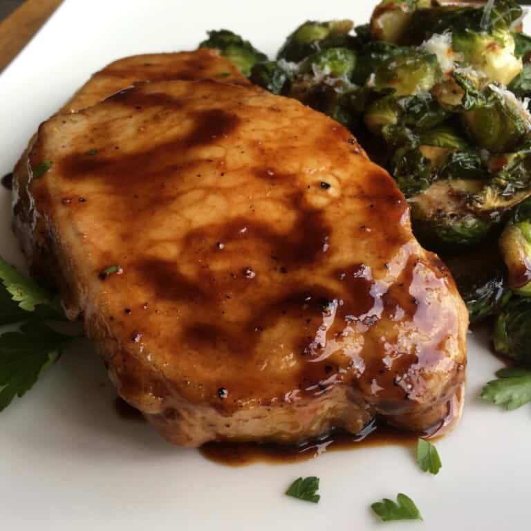 Balsamic pork chops with Brussels sprouts on a plate.