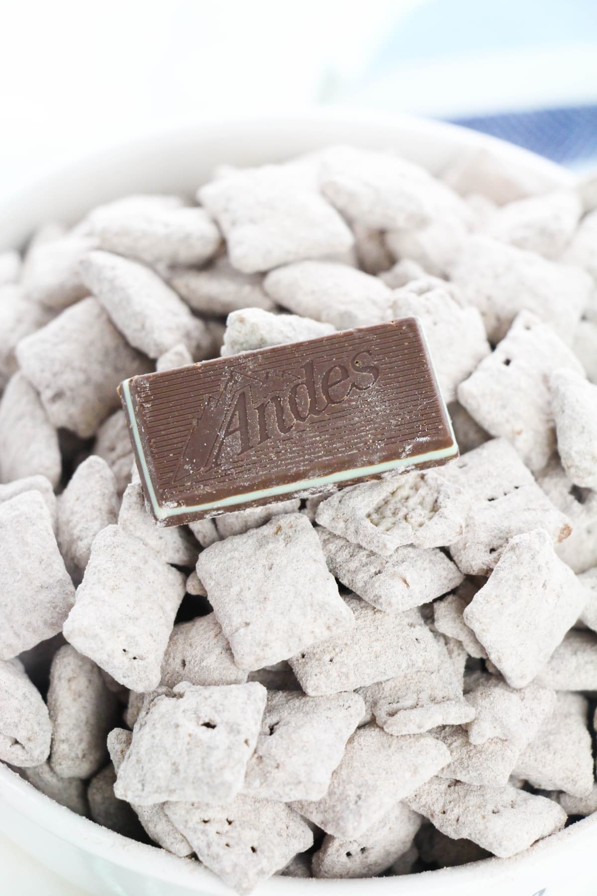 Chex cereal coated with chocolate and powdered sugar topped with one Andes mint chocolate.
