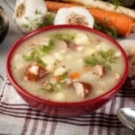 A bowl of soup on a table.