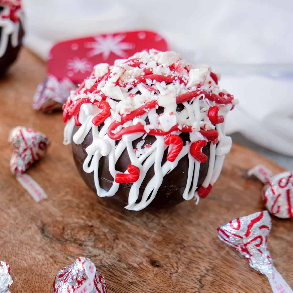 Peppermint Cocoa Bomb on a wooden board.