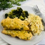 A plate of Chicken and Gravy, rice, and broccoli.