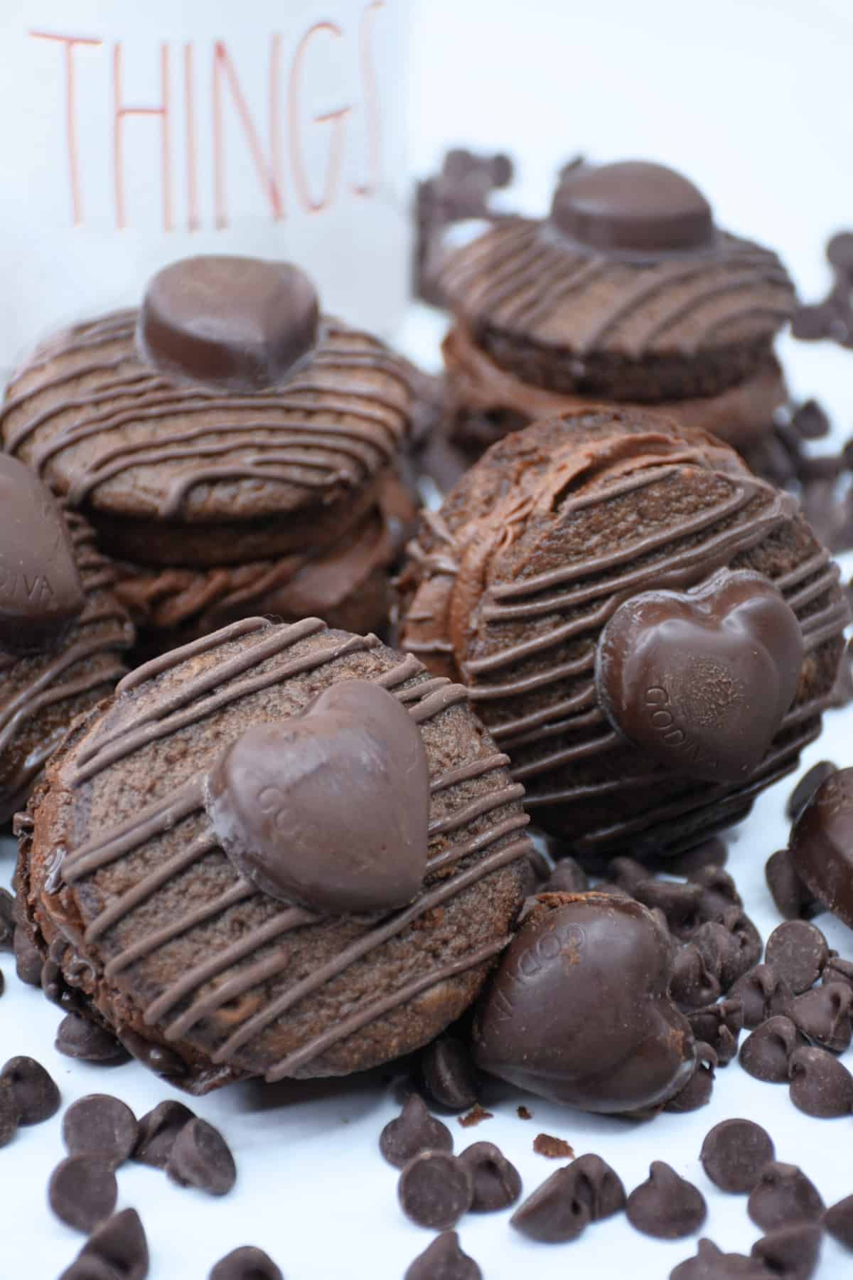 Chocolate Whoopie Pies drizzled with melted chocolate topped Godiva heart.