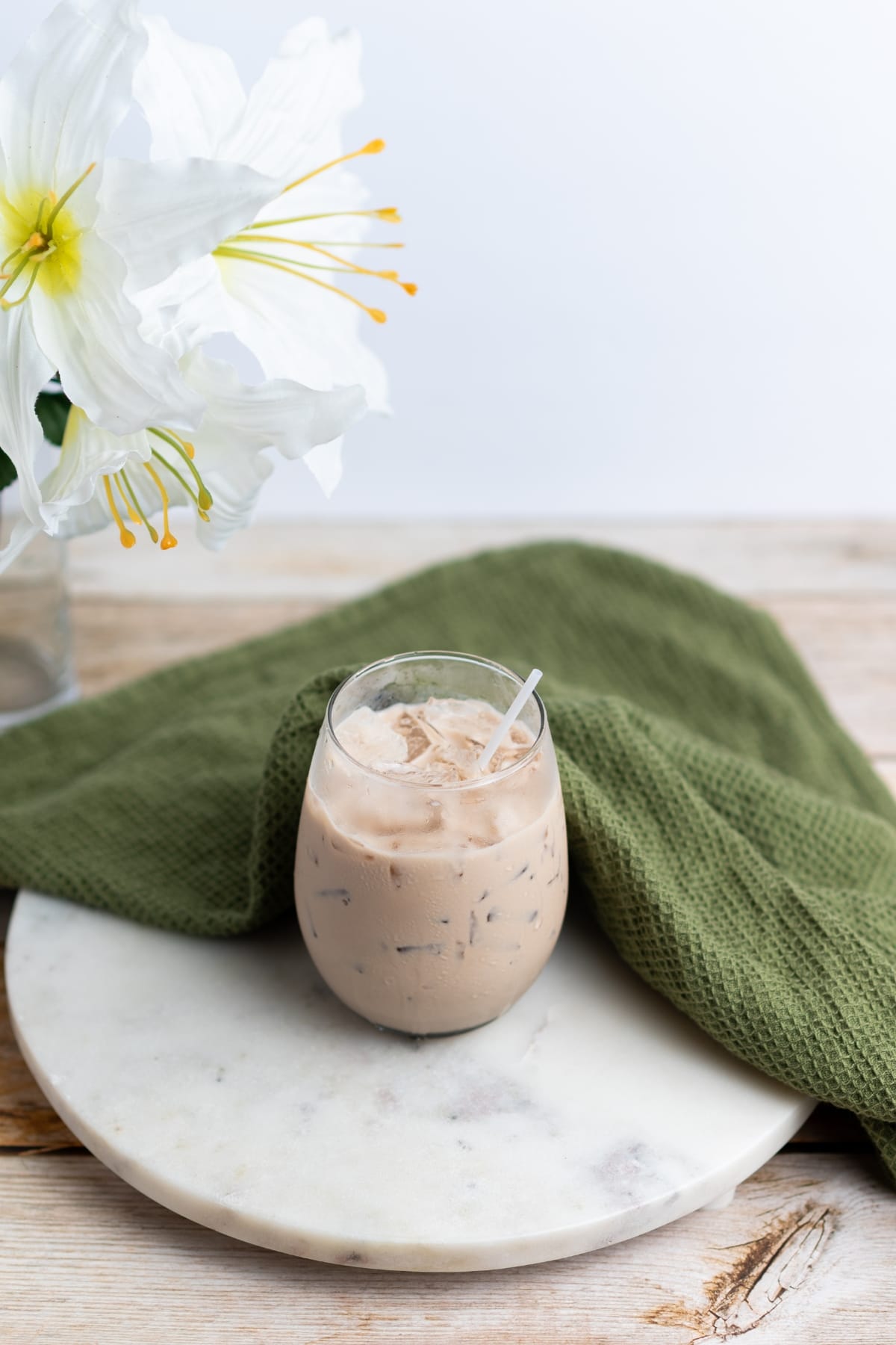 A glass of Bailey’s Irish cream sitting on a marble tray.