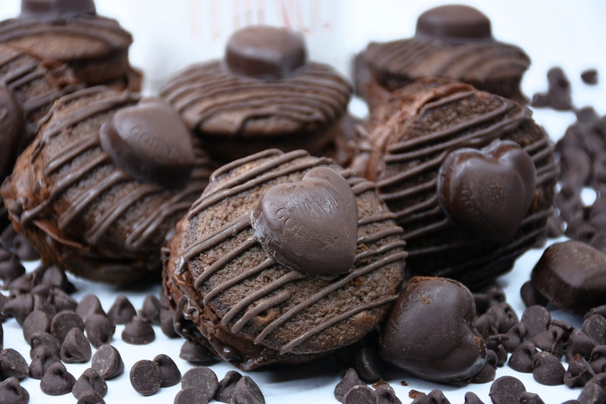 Chocolate whoopie pies drizzled with Godiva heart in the center surrounded with chocolate chips.