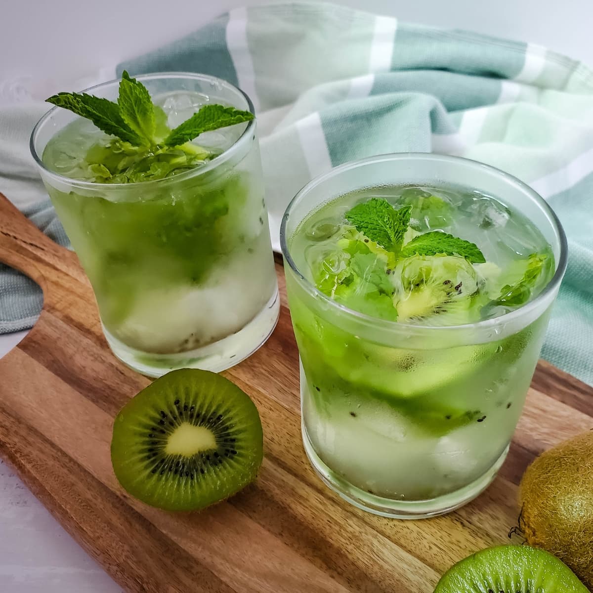 Kiwi and Mint Mojito Cocktail on a wooden board.