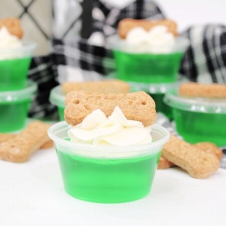 Green Jello shot topped with whipped cream and a Scooby snack.