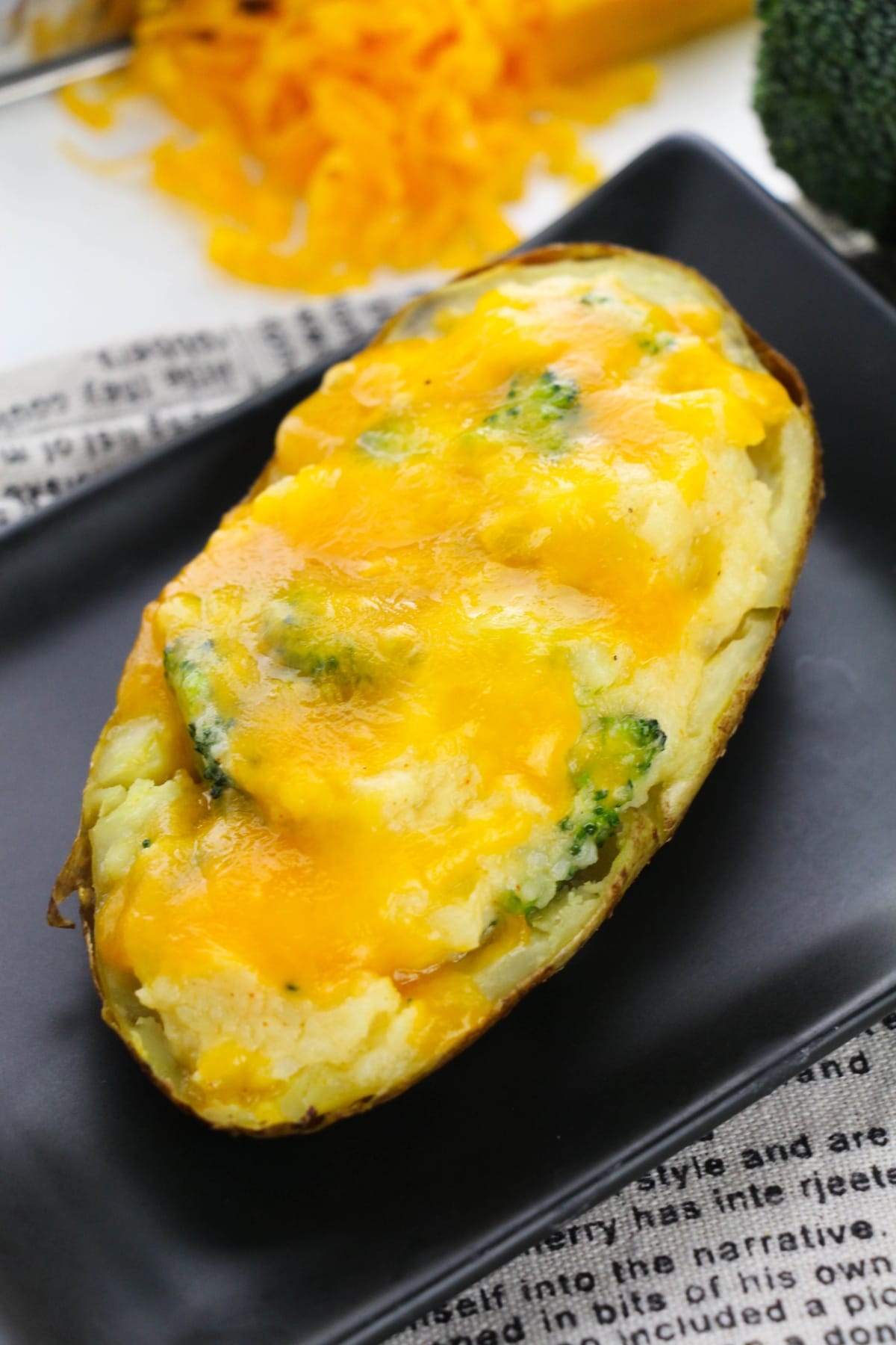 Stuffed potatoes sitting on a black plate.
