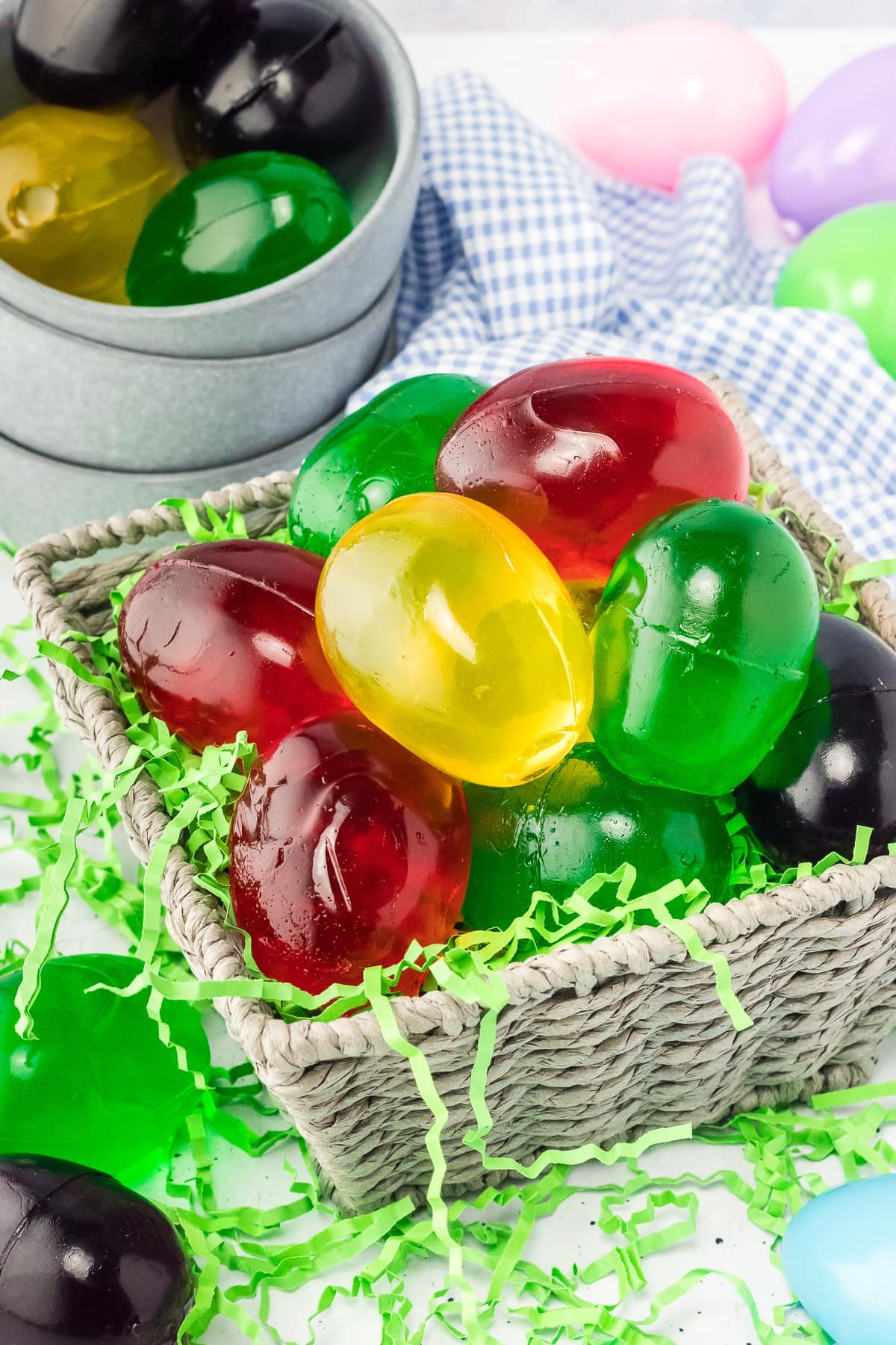Pile of egg-shaped Jello Shots in a basket.