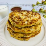Loaded Pancakes Stacked on a white plate.