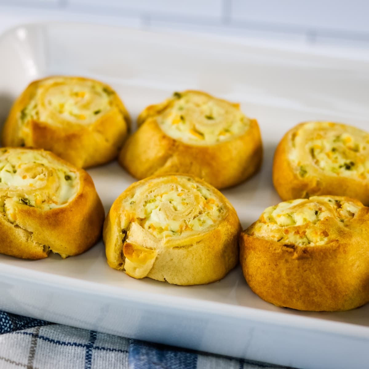 A white plate of Jalapeno Popper Crescent Rolls.