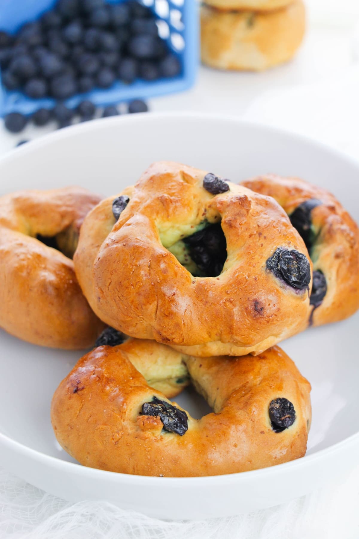 Bagels with blueberry on a white plate.