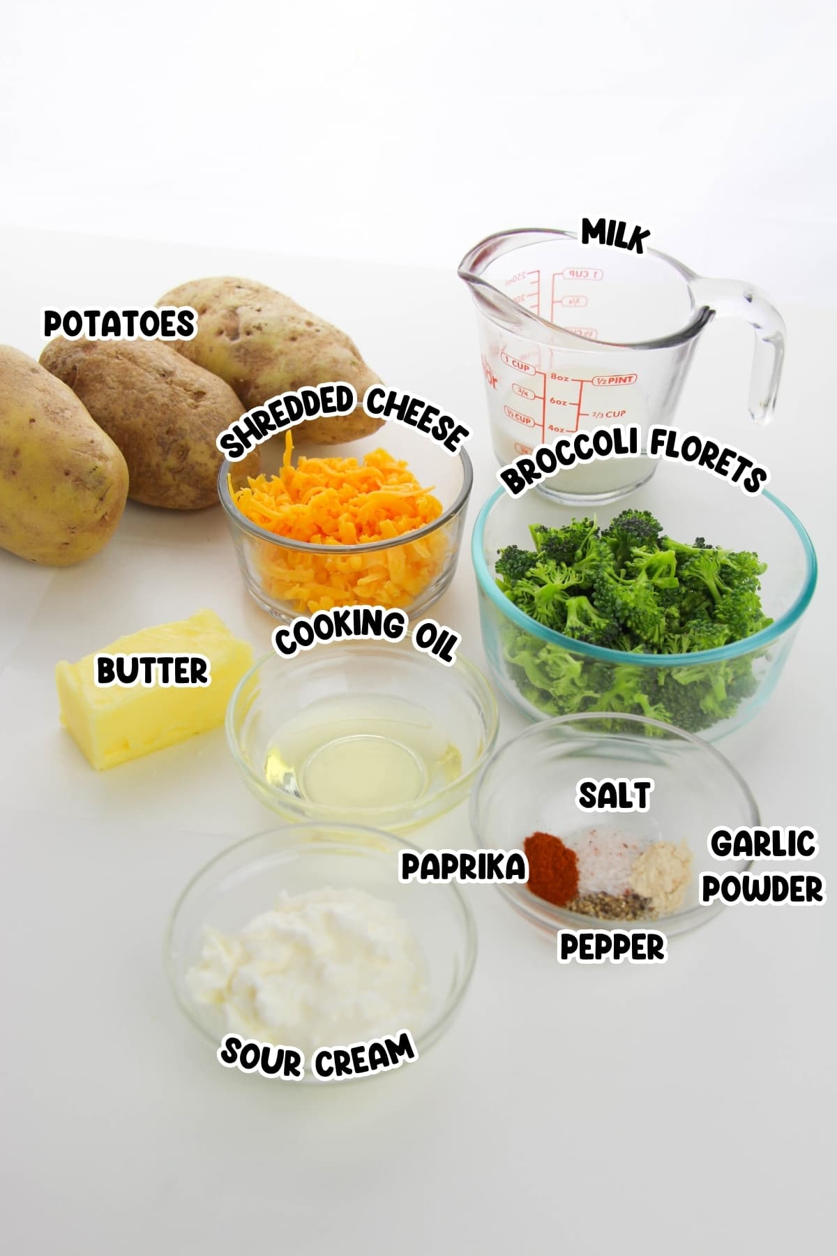 Ingredients for Broccoli Cheddar Twice Baked Potatoes sitting on a white countertop.