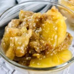 Glass bowl of caramel apple dump cake.