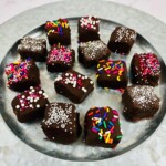 Chocolate candy bars with sprinkles on a plate.