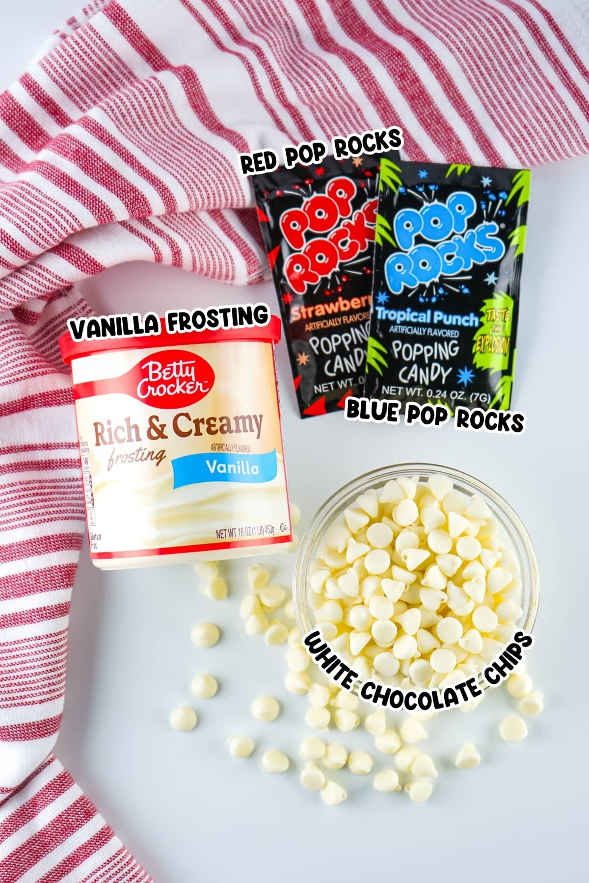 Ingredients for patriotic fudge including vanilla frosting, pop rocks, and white chocolate chips.