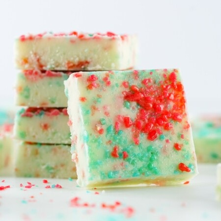 A pile of white chocolate fudge with red and blue pop rocks on top.