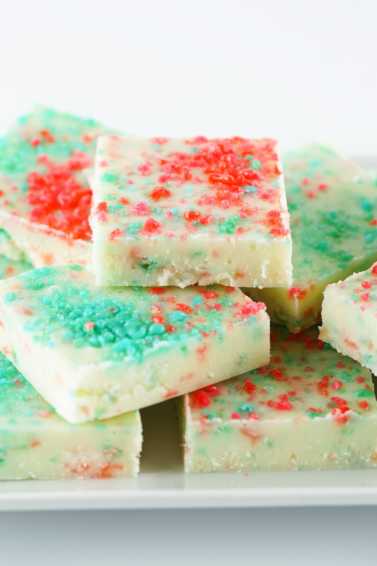 Slices of white chocolate fudge with popping candy on top.