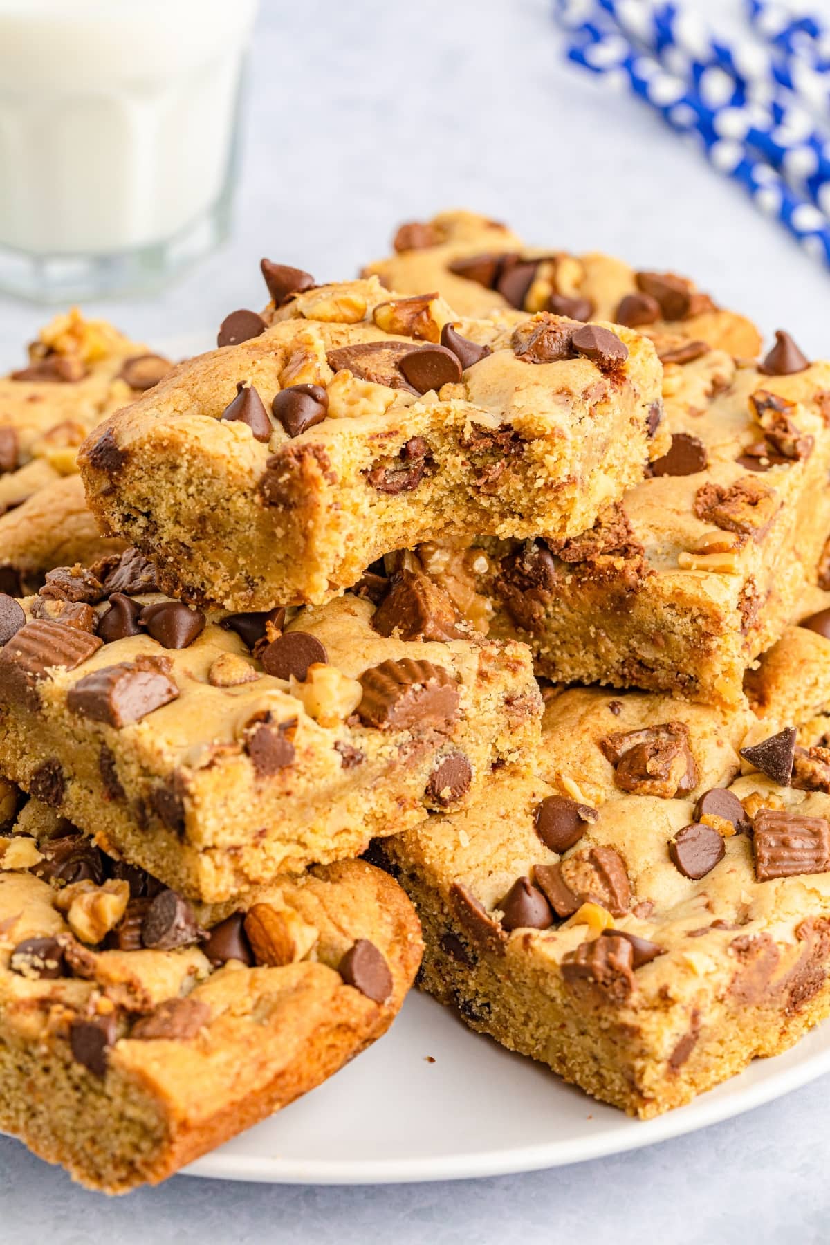 A pile of cookie bars on a white plate.