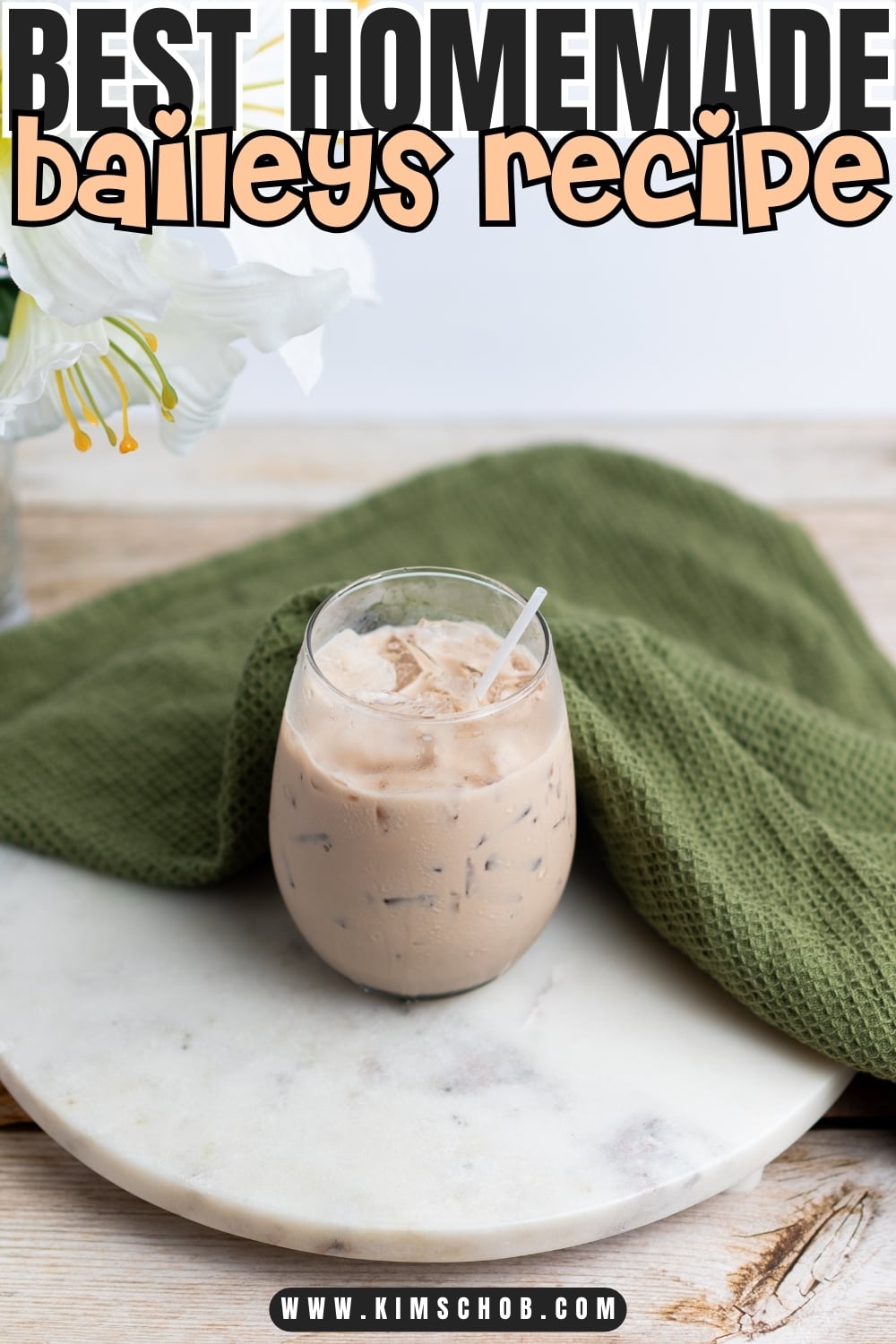 Irish cream liqueur sitting on a round marble tray.
