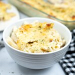 Ziti pasta in a bowl topped with parsley.