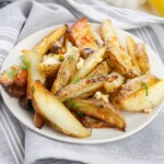 Potatoes with dill and feta cheese on a plate.
