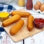 Corn Dogs on a wooden cutting board.