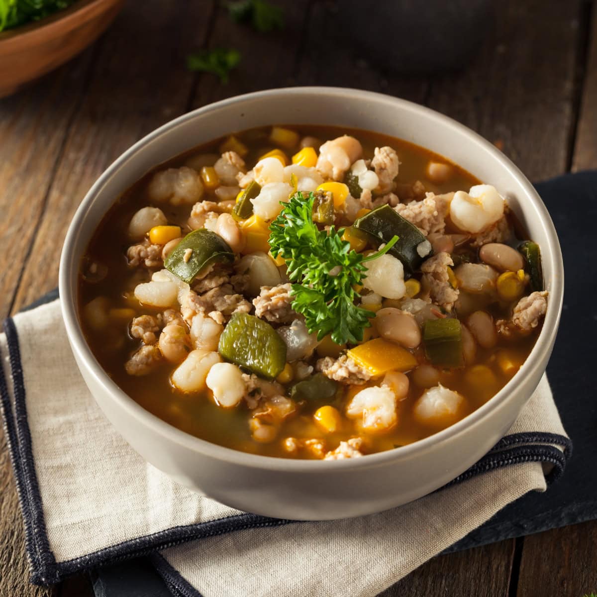 Southwestern Chicken Soup garnished with cilantro in a white bowl.