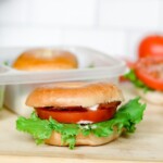 Mini BLT Bagel Sandwich on a wooden board.