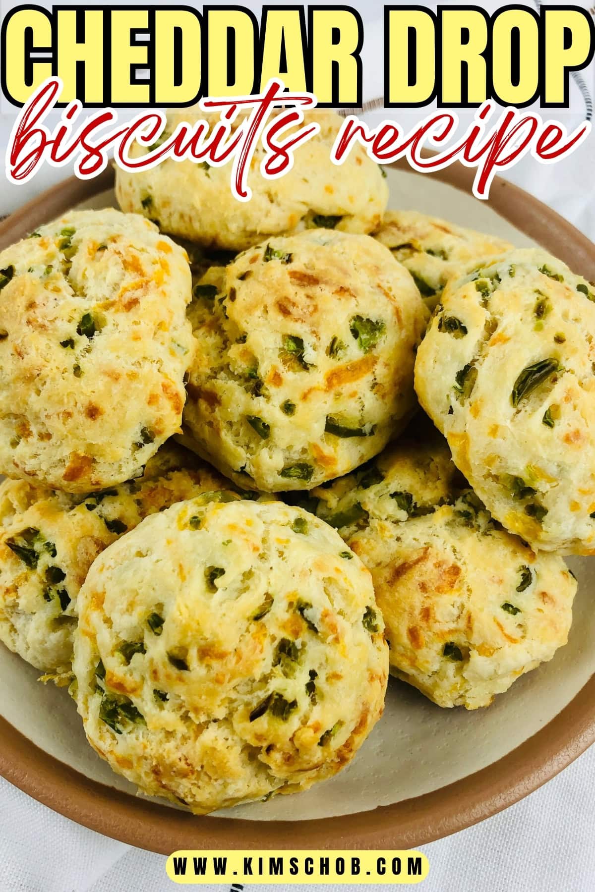 A pile of cheddar biscuits sitting on a beige plate.