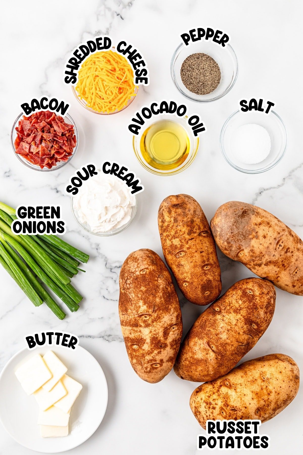 Ingredient for Baked Potatoes sitting on a marble countertop.