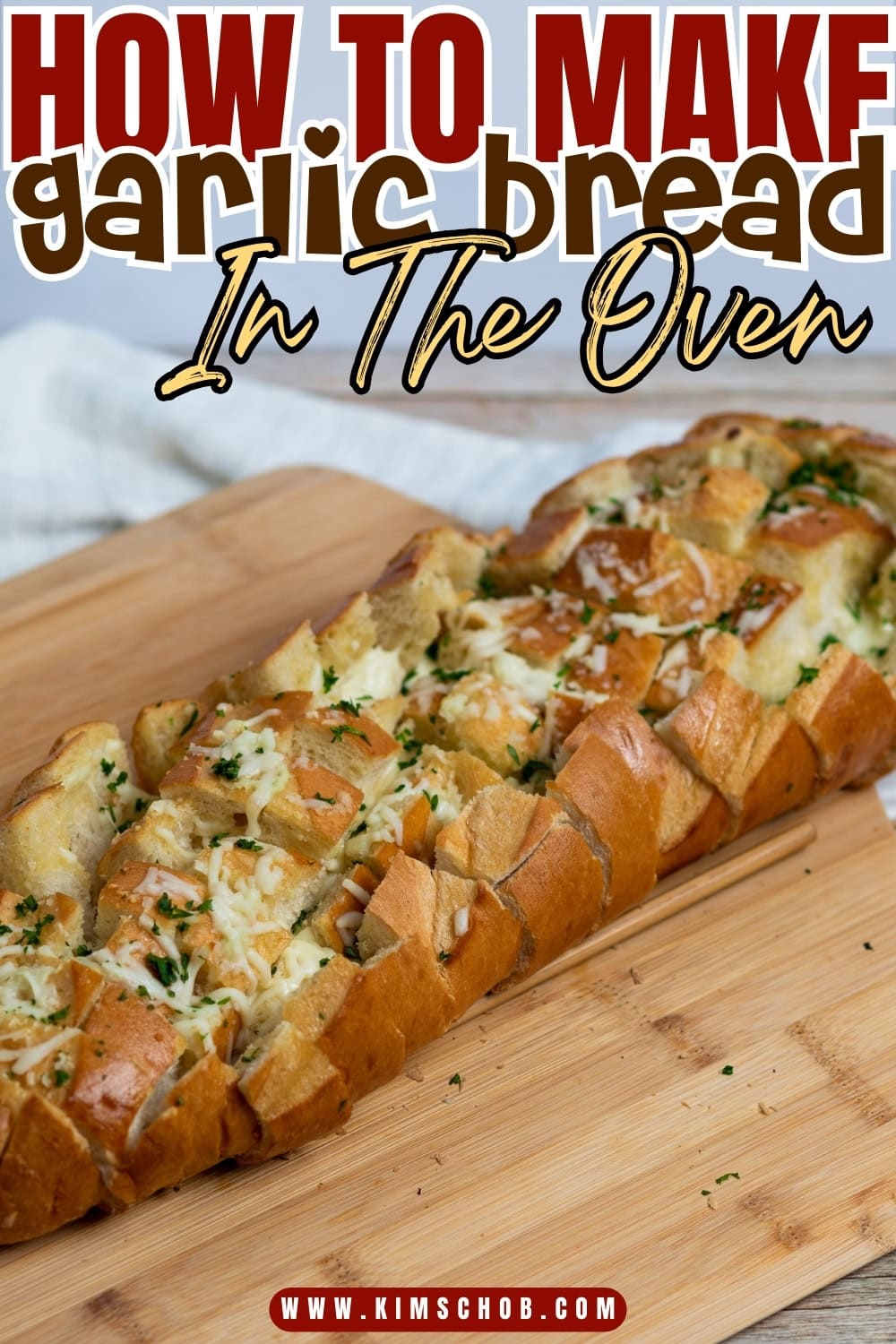 A wooden board with French baguette with zig zag cut topped with cheese and chopped parsley.