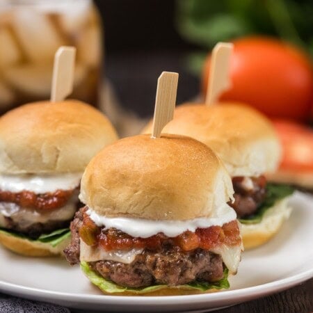 Three Mexican Burger Sliders on a white plate.
