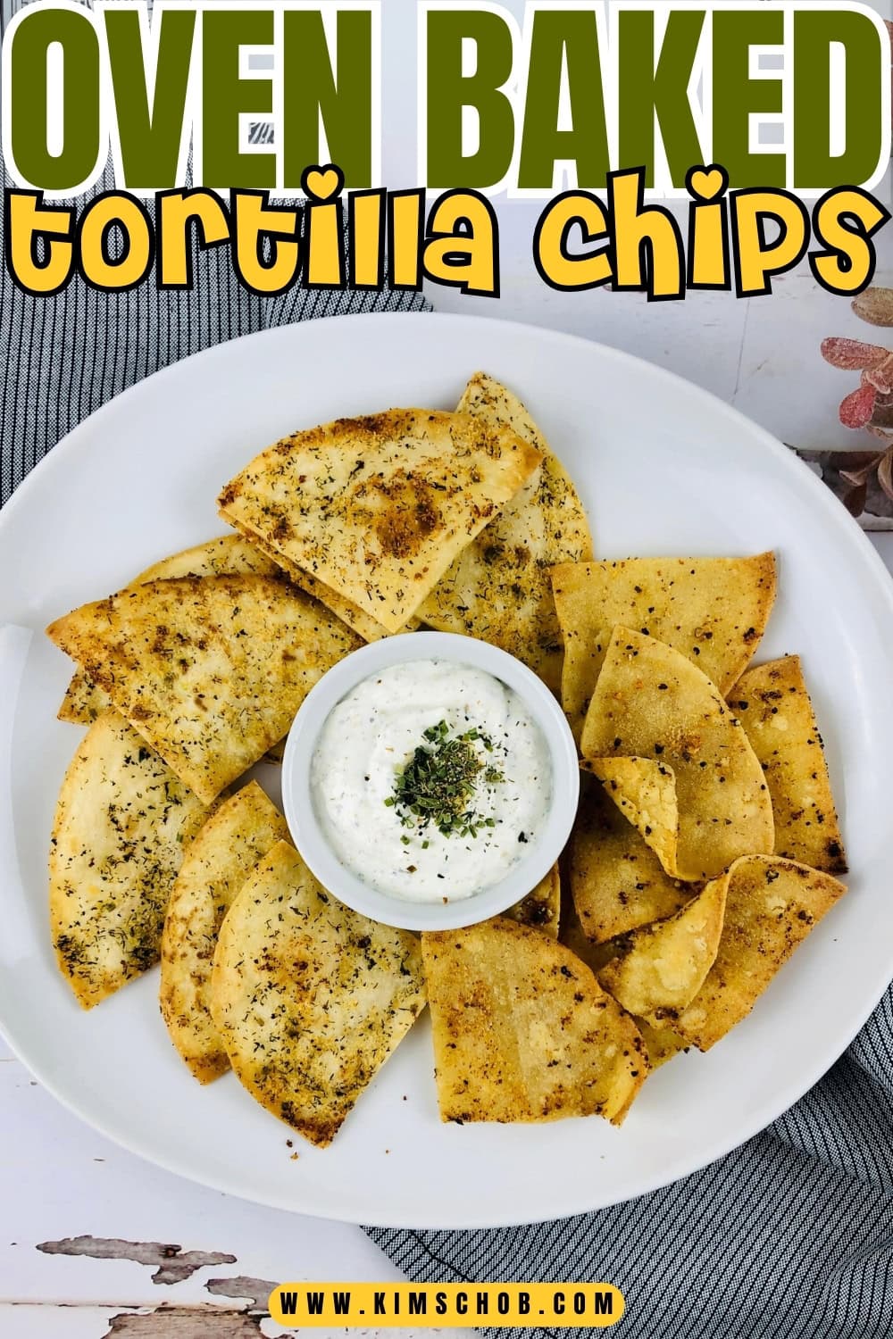 A white plate of tortilla chips with dip sauce on the center.