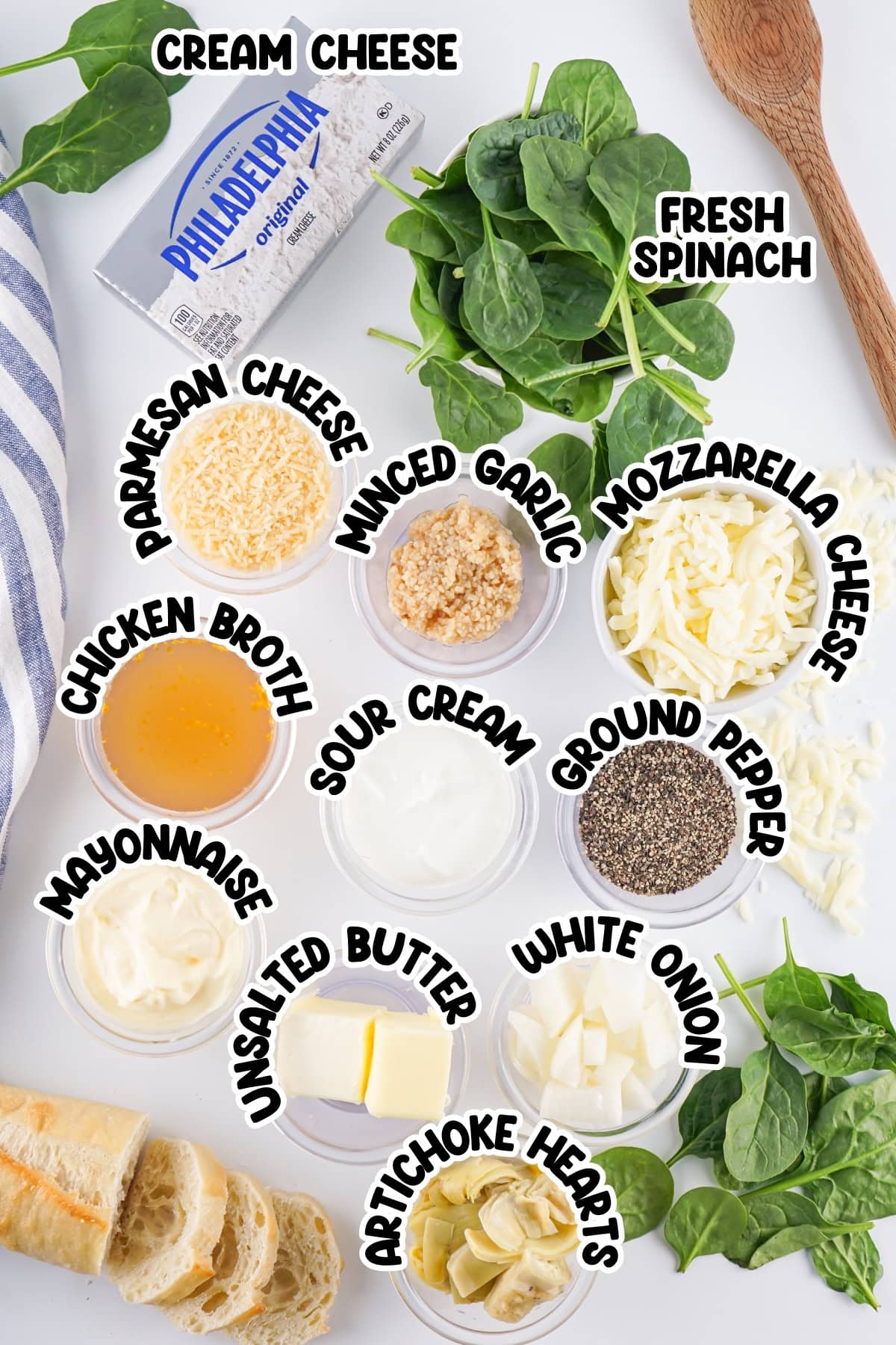 Ingredient for spinach artichoke dip sitting on a white countertop.