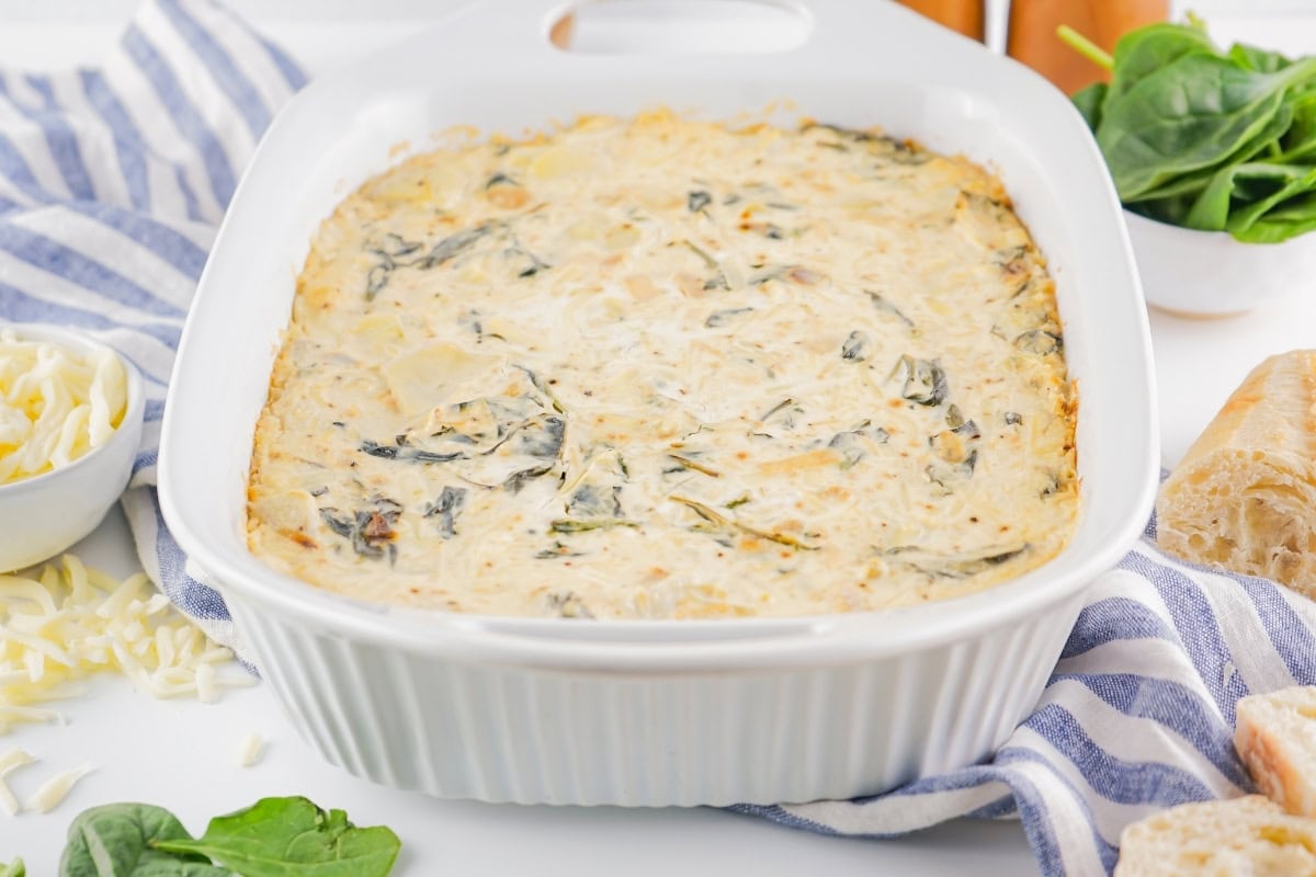 White casserole with spinach artichoke dip.