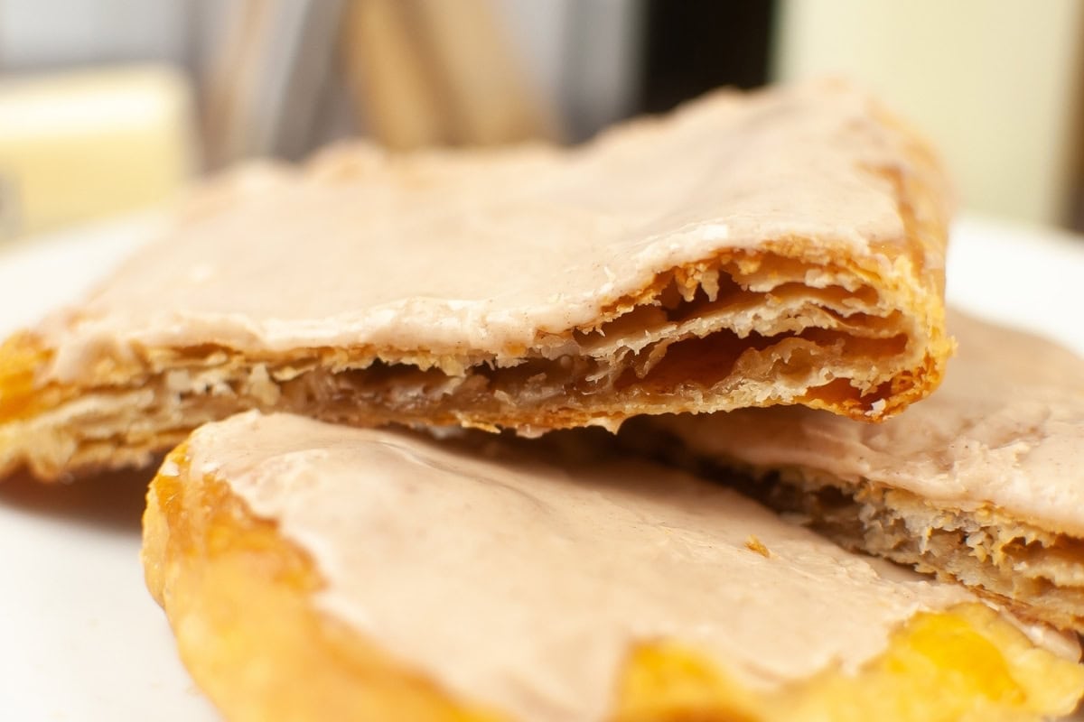 Pop tarts with brown sugar and cinnamon mixture filling topped with powdered sugar and cinnamon icing.