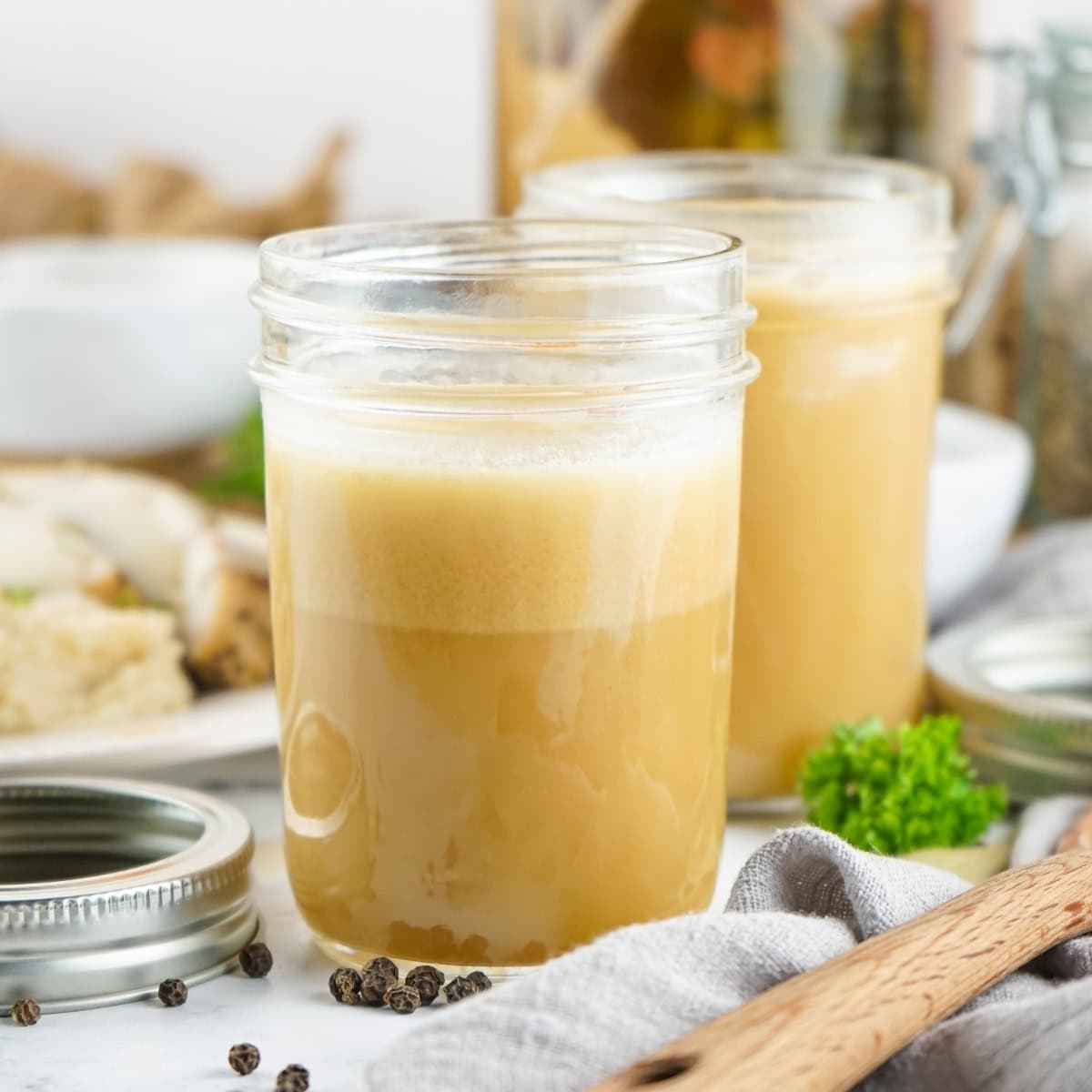 Two air tight containers with Rotisserie Chicken Stock.