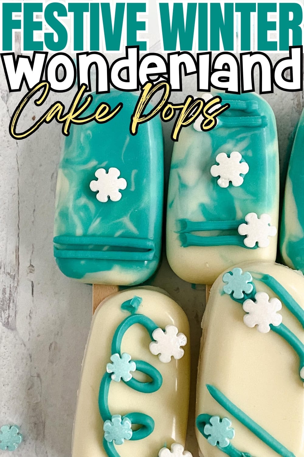 Cake pops covered in a white and blue candy melts decorated with snowflakes sprinkles.