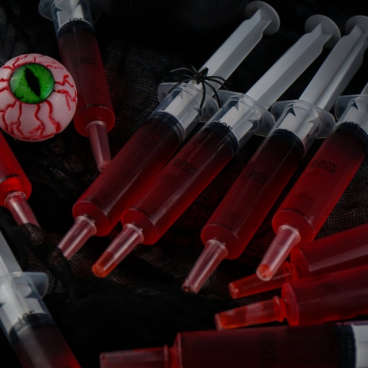 Red jello shots in syringes.